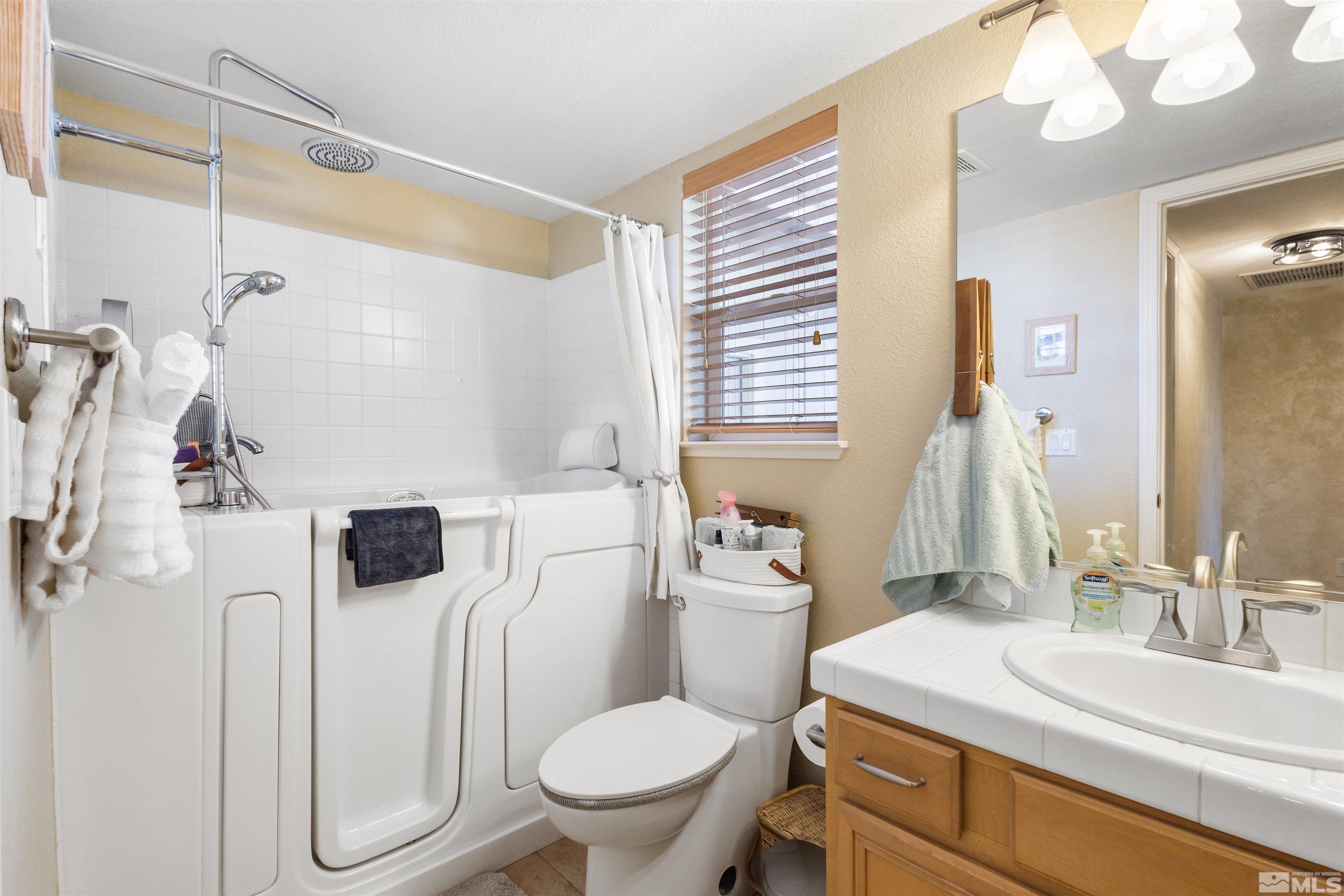608 Sugar Tree Court Reno, NV 89511 - Photo 18 of 40 a bathroom with a sink toilet vanity and shower