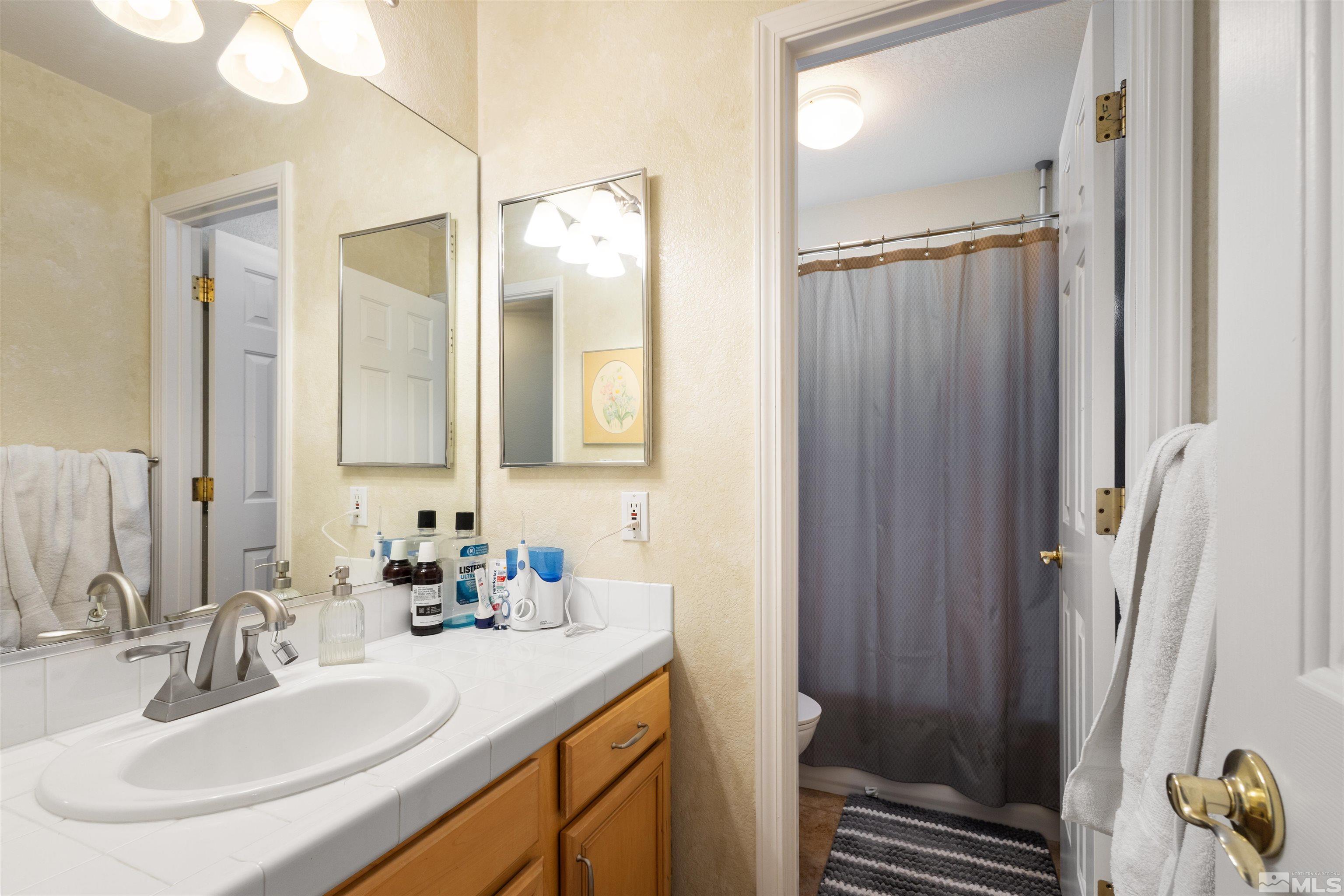 608 Sugar Tree Court Reno, NV 89511 - Photo 21 of 40 a bathroom with a sink double vanity and a mirror