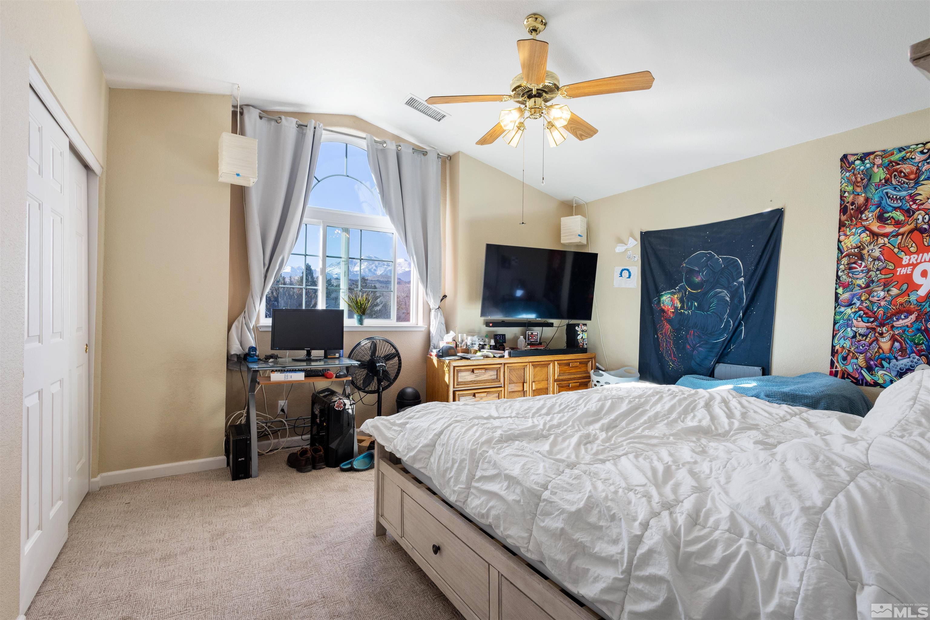 608 Sugar Tree Court Reno, NV 89511 - Photo 22 of 40 a bed room with a bed and a flat tv screen