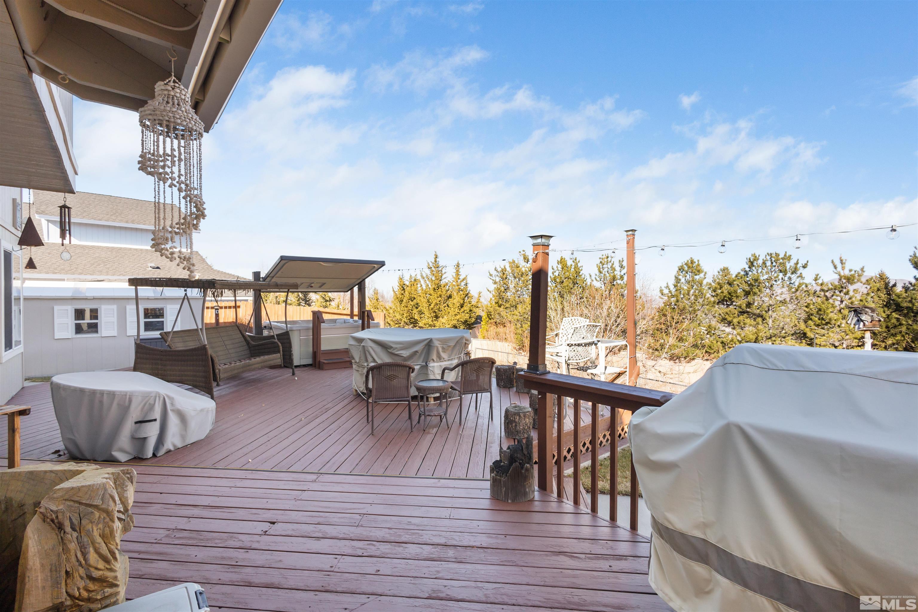 608 Sugar Tree Court Reno, NV 89511 - Photo 29 of 40 a view of a patio with couches chairs dining table and chairs with wooden floor