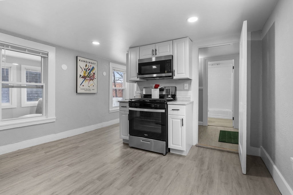 15 Reservoir Street Worcester, MA 01605 - Photo 12 of 35 a kitchen with granite countertop white cabinets and appliances