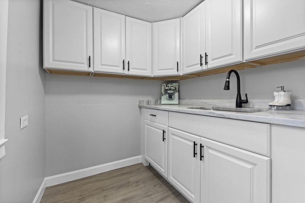 15 Reservoir Street Worcester, MA 01605 - Photo 15 of 35 a kitchen with stainless steel appliances granite countertop white cabinets and a sink