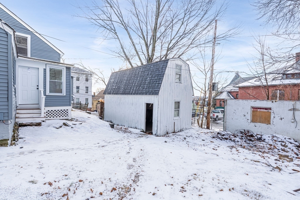 15 Reservoir Street Worcester, MA 01605 - Photo 27 of 35 a view of a house with a yard covered in snow