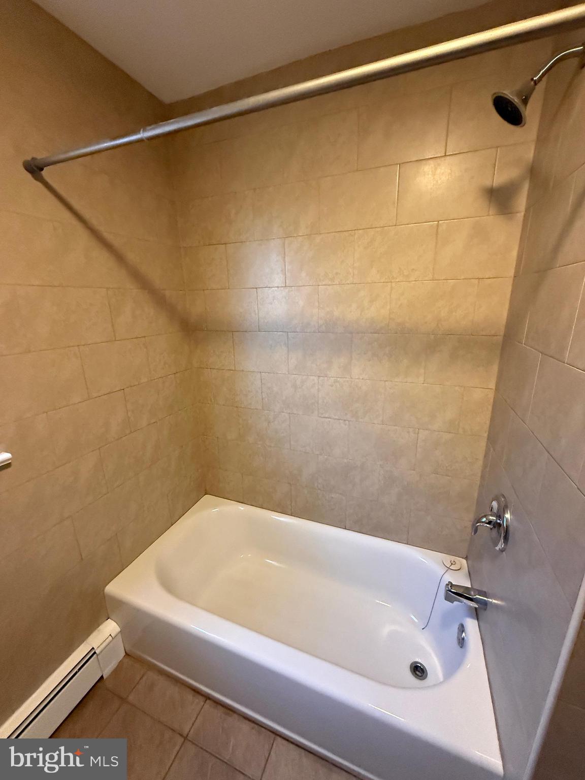 304 Walnut Street, Unit B Waynesboro, PA 17268 - Photo 15 of 17 a bathroom with a white bath tub and a shower in a bathroom