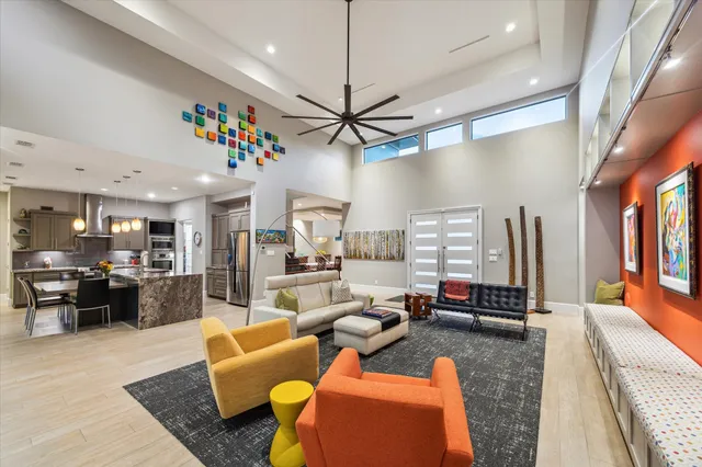a living room filled with furniture and a chandelier