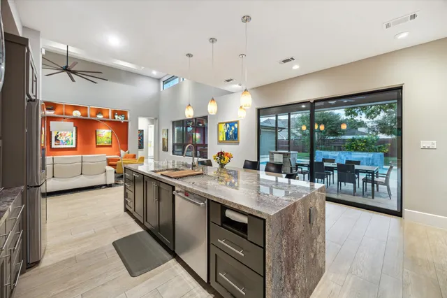 a open kitchen with stainless steel appliances granite countertop a lot of counter space and a wooden floors