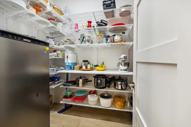 a utility room with stainless steel appliances and white walls