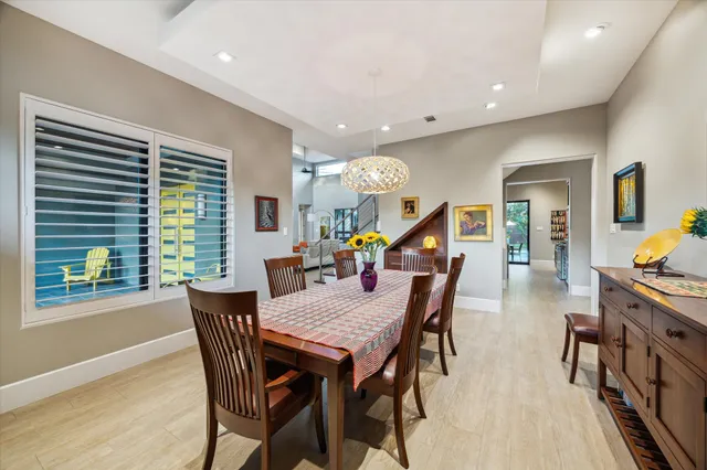 a view of a dining room with furniture and a potted plant