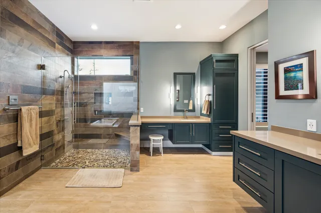 a large bathroom with a tub a sink and glass door