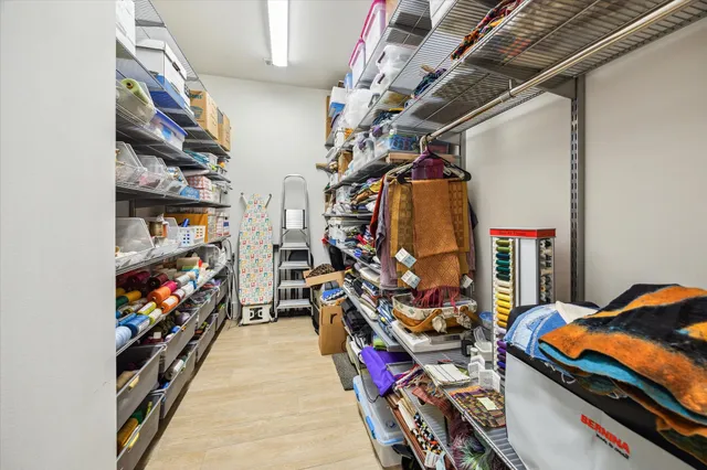 a view of walk in closet with clothes and shoes
