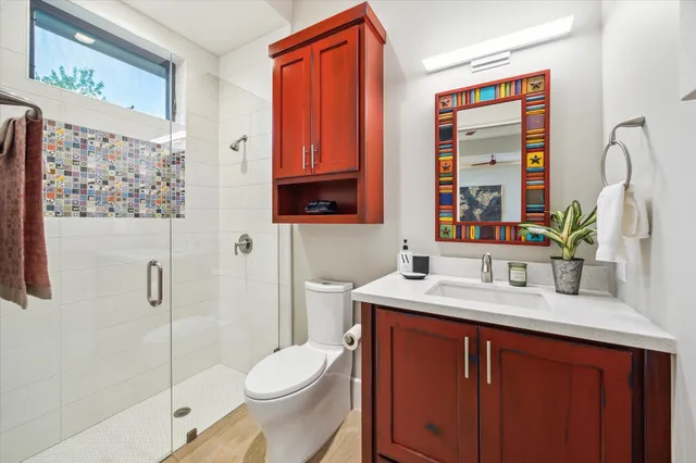 a bathroom with a sink toilet and shower
