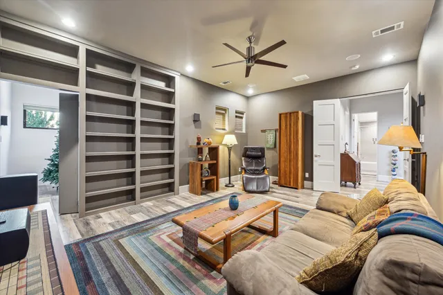 a living room with furniture a ceiling fan and a rug