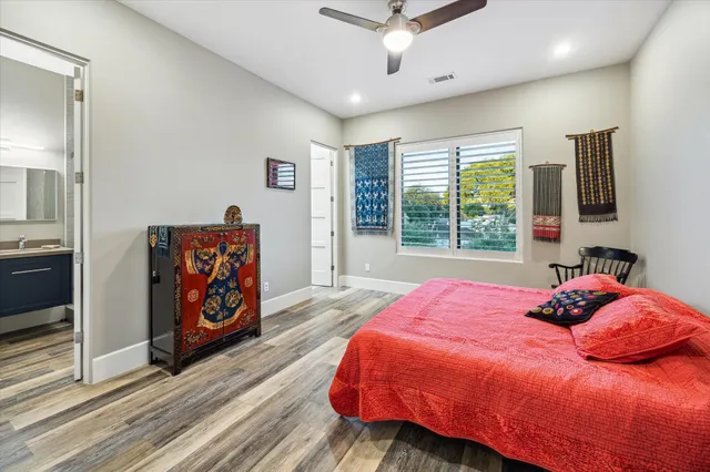 a bedroom with a bed dresser and window
