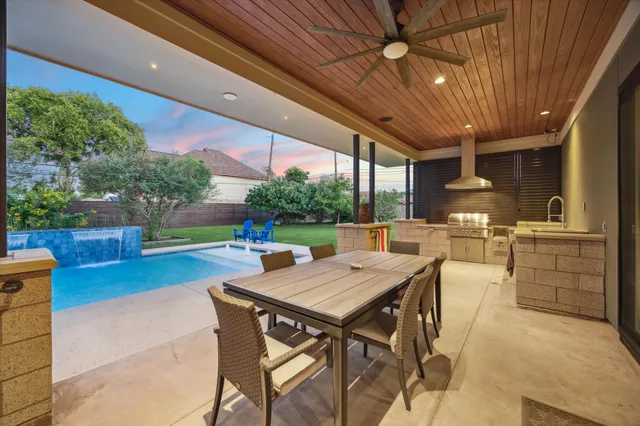 a view of a dining table and chairs in the patio