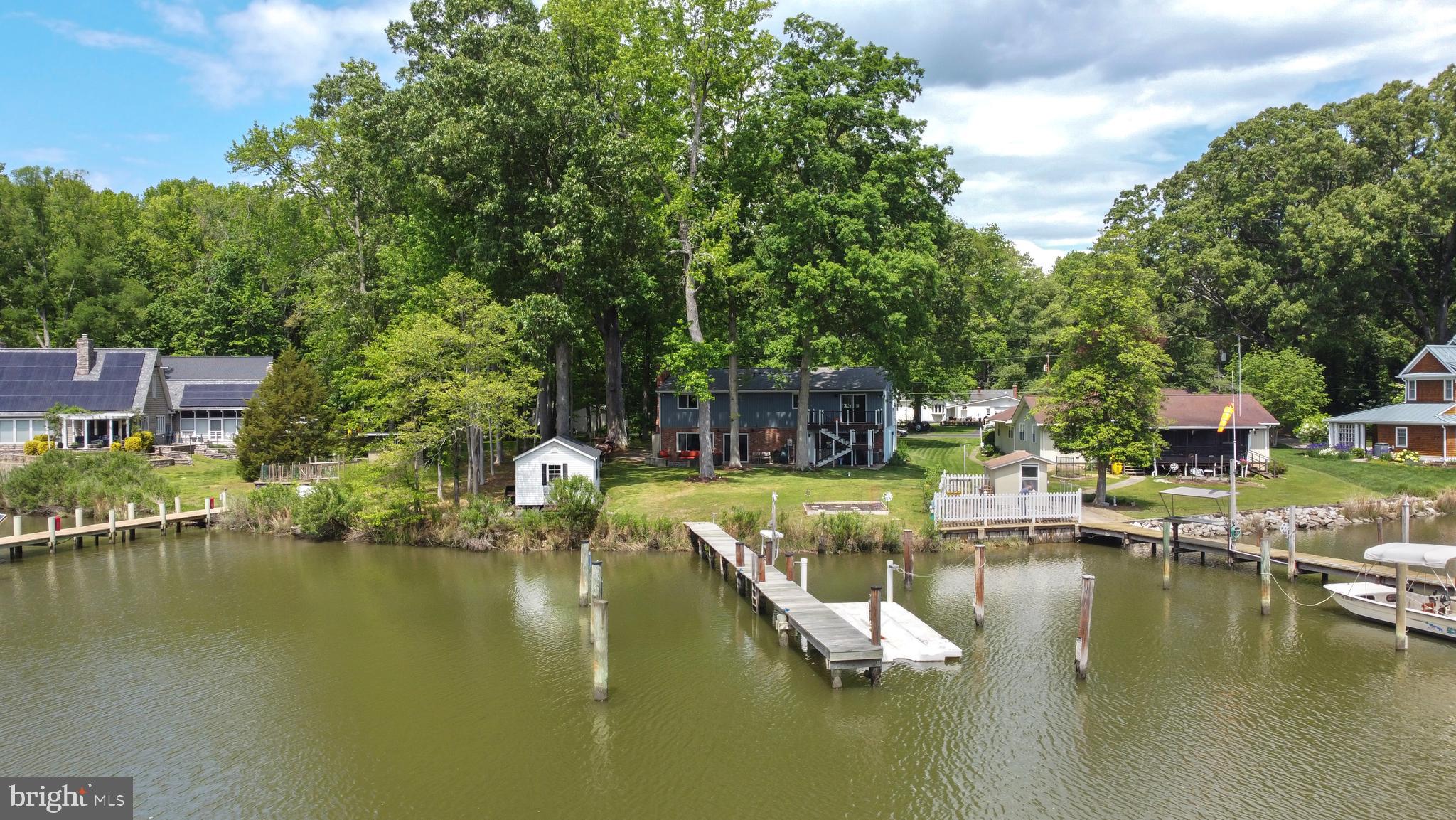 a view of house with swimming pool and outdoor seating