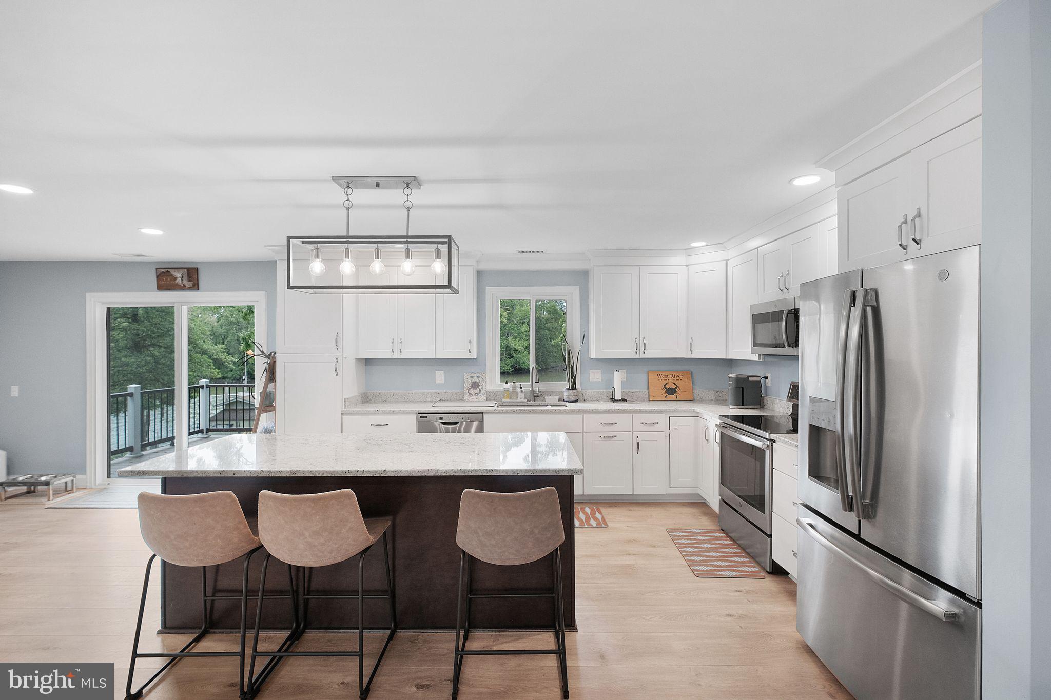 819 Elm Drive West River, MD 20778 - Photo 13 of 39 a kitchen with refrigerator cabinets and chairs