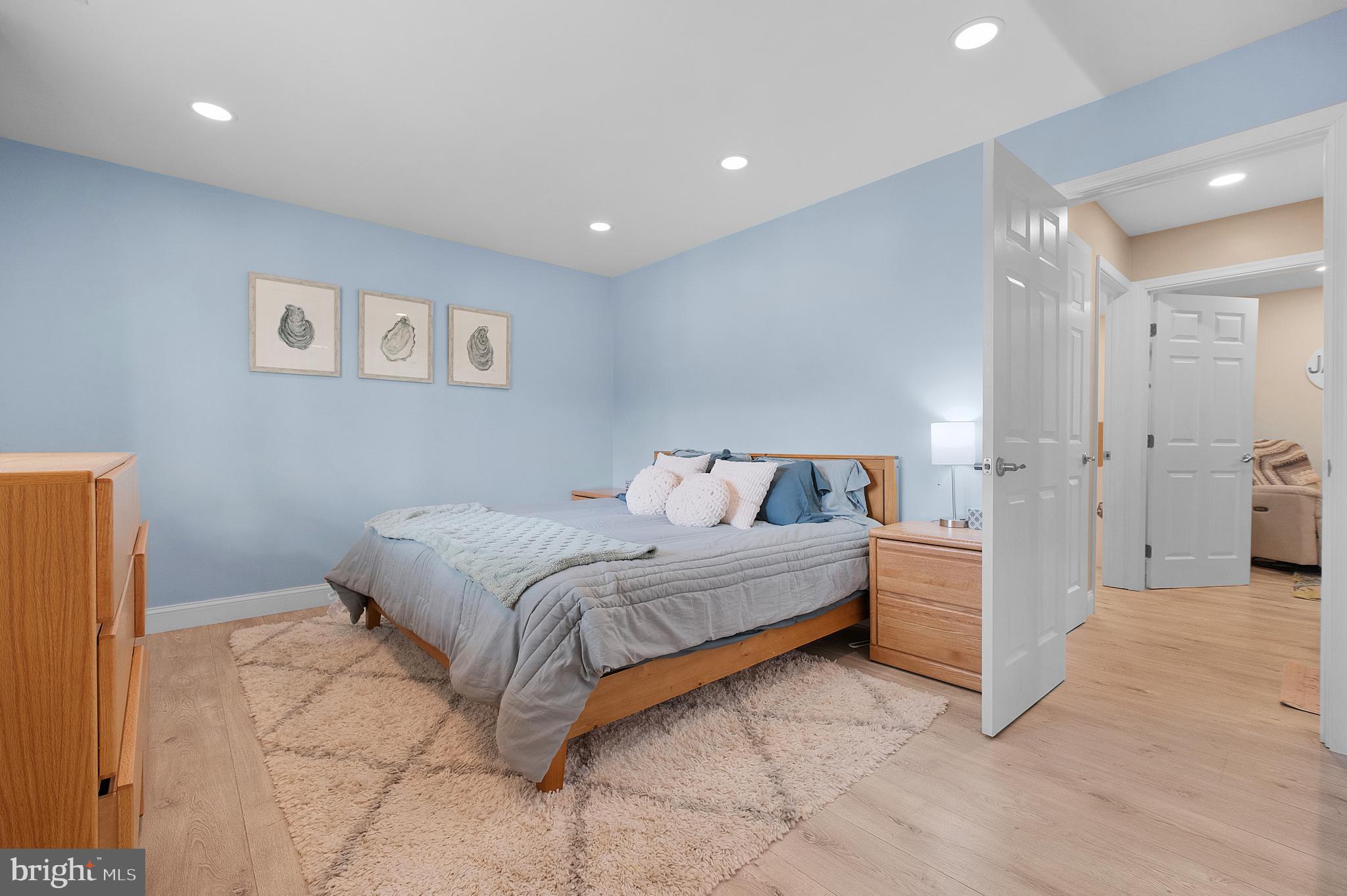 819 Elm Drive West River, MD 20778 - Photo 15 of 39 a spacious bedroom with a bed and a painting