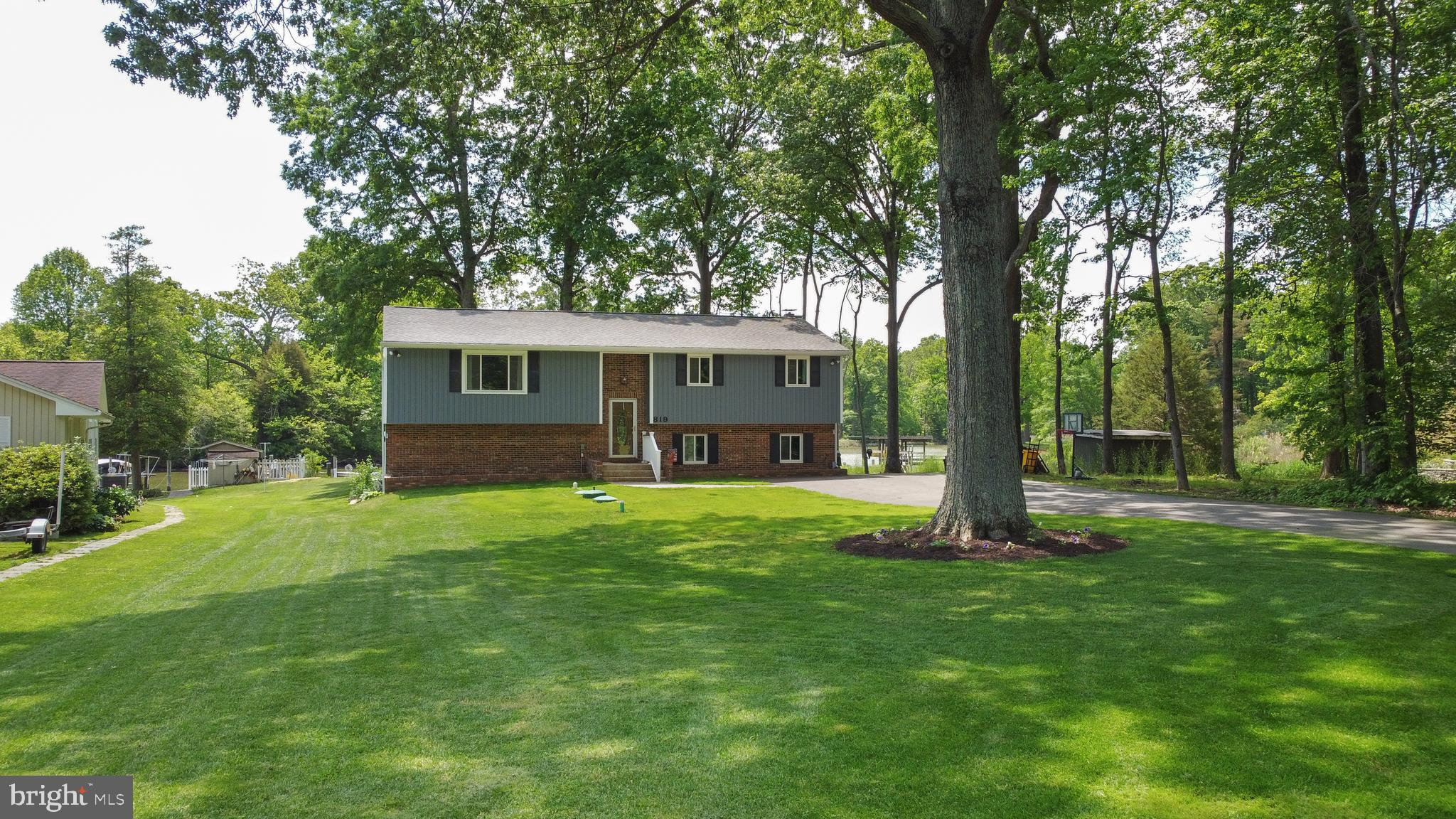 819 Elm Drive West River, MD 20778 - Photo 2 of 39 a view of a house with a yard and a tree