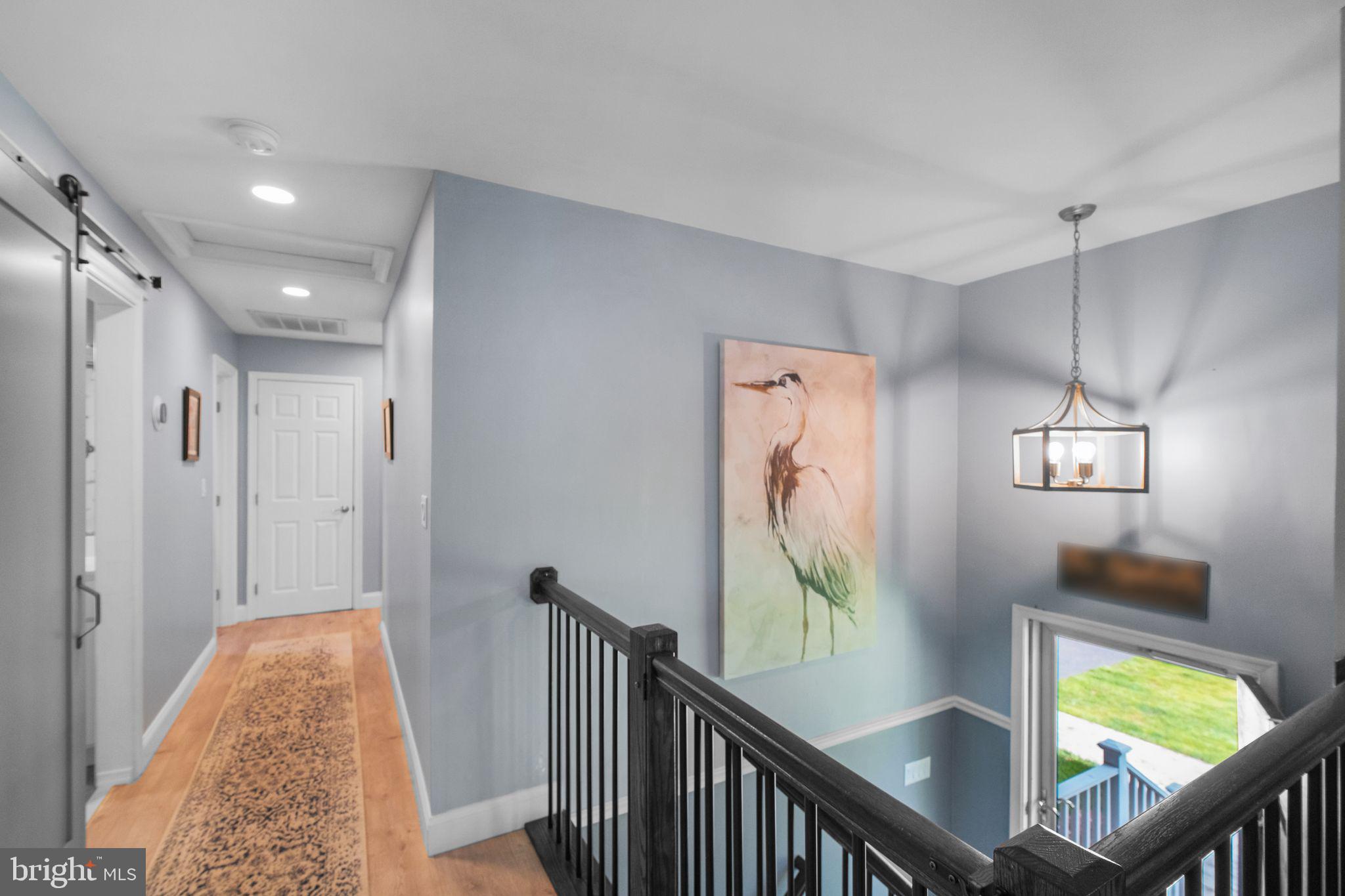 819 Elm Drive West River, MD 20778 - Photo 21 of 39 a view of hallway with wooden floor and stairs