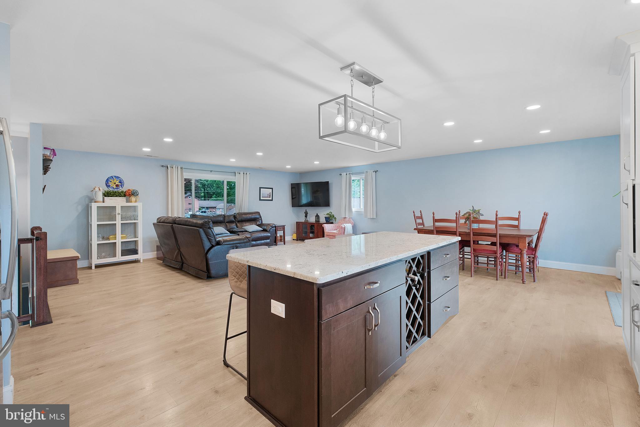 819 Elm Drive West River, MD 20778 - Photo 10 of 39 a open kitchen with stainless steel appliances granite countertop a table chairs and a refrigerator