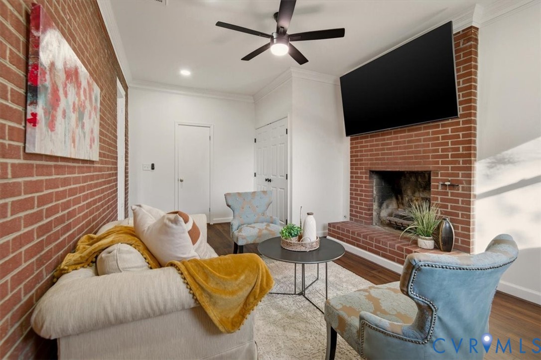 2720 Omega Road Henrico, VA 23228 - Photo 23 of 45 Den featuring brick wall, crown molding, LVP fl