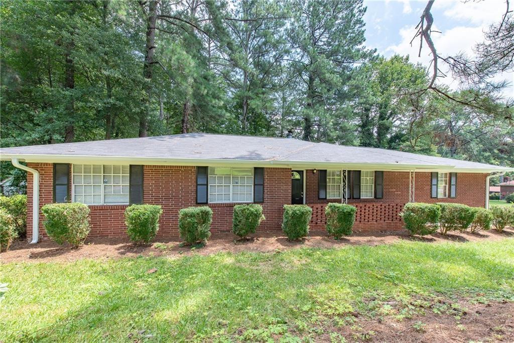 5045 Glore Road Southwest Mableton, GA 30126 - Photo 1 of 1 a view of a house with a yard and plants