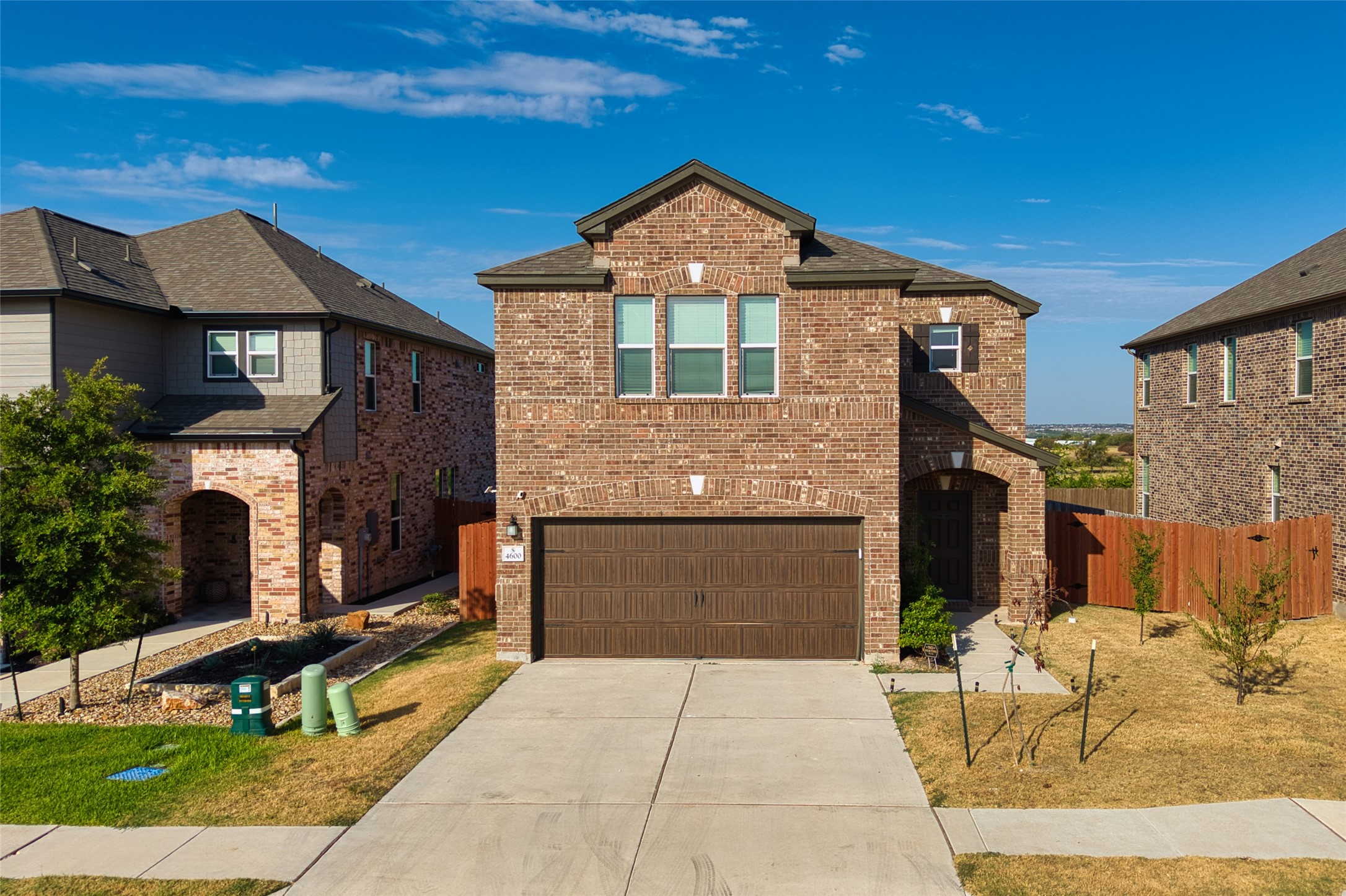 4600 Alfano Loop Round Rock, TX 78665 - Photo 29 of 34 Front view featuring the home's brick exterior, driveway, and surrounding residential setting.