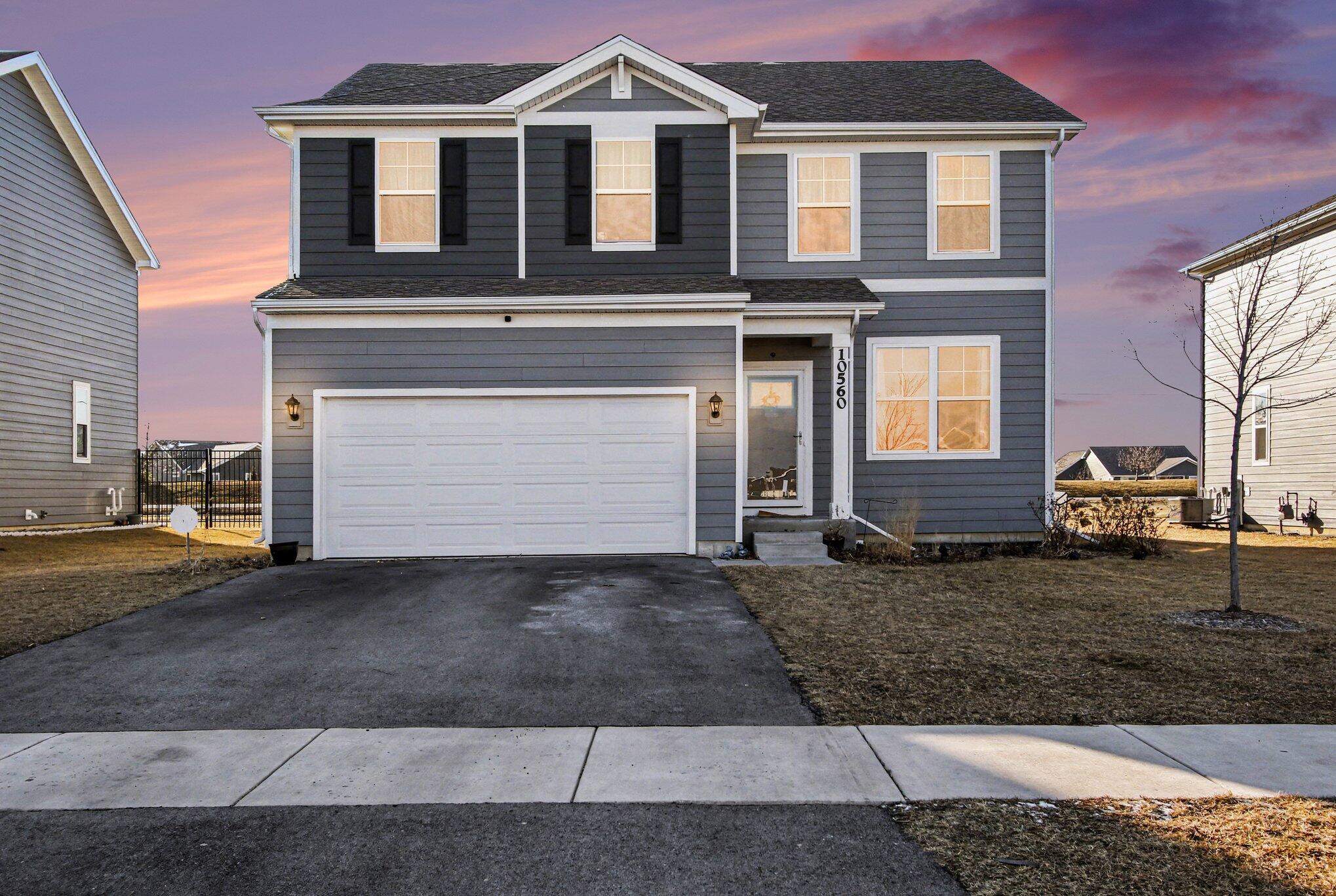 a front view of a house with a yard