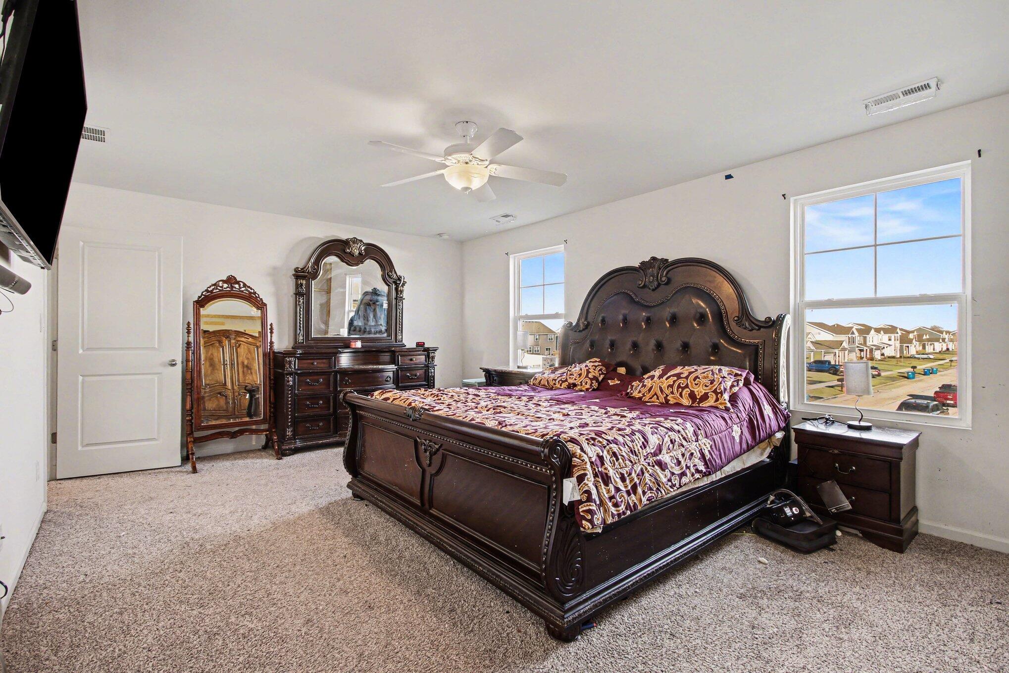 10560 Azalea Drive Crown Point, IN 46307 - Photo 16 of 26 a bedroom with a bed a dresser next to a window