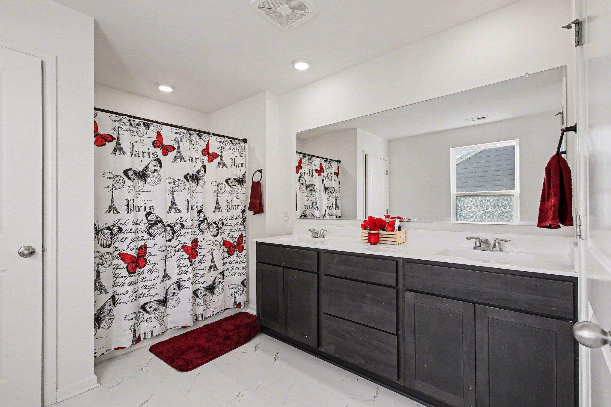 10560 Azalea Drive Crown Point, IN 46307 - Photo 17 of 26 a bathroom with a sink vanity mirror and shower