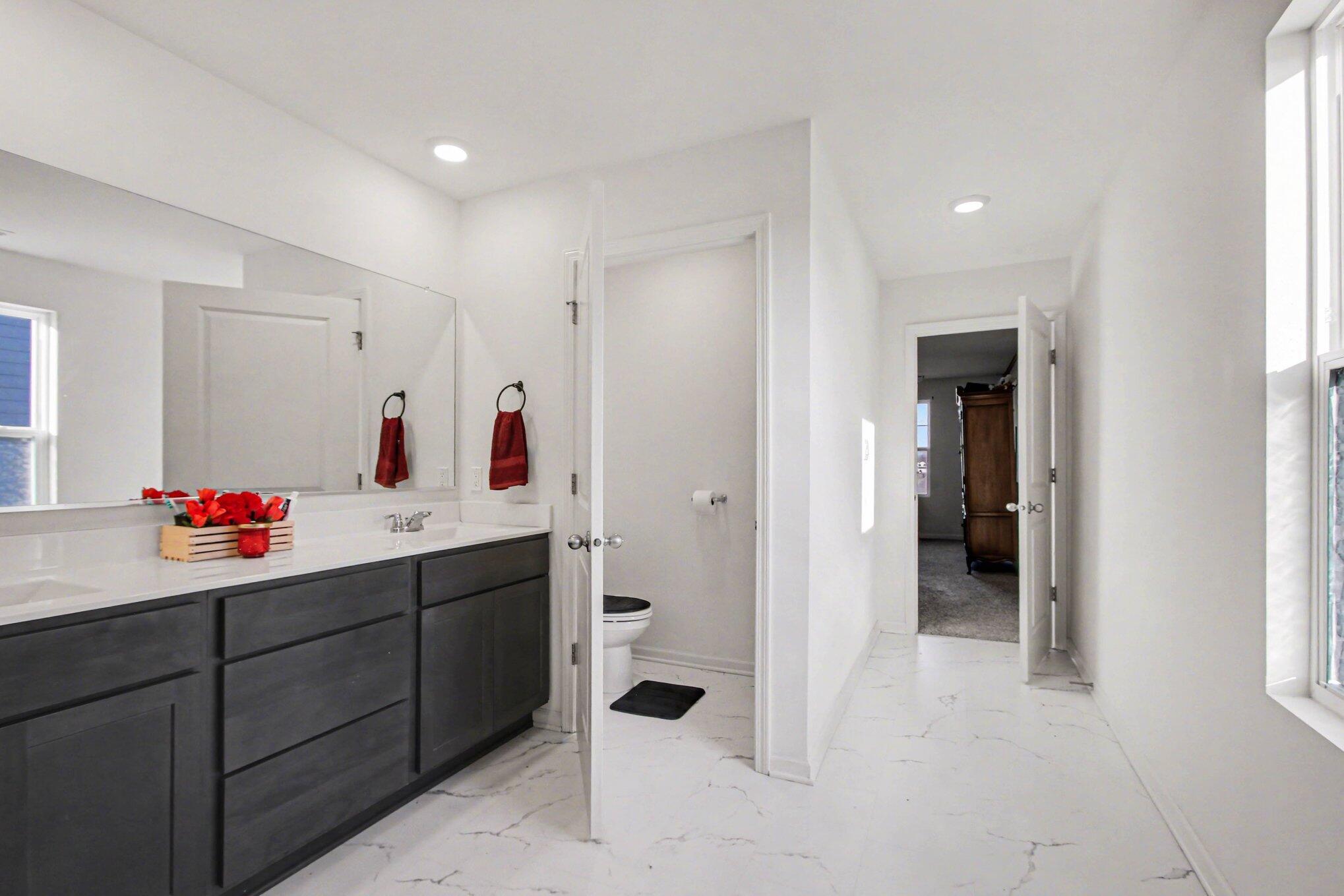 10560 Azalea Drive Crown Point, IN 46307 - Photo 18 of 26 a bathroom with a double vanity sink mirror and shower