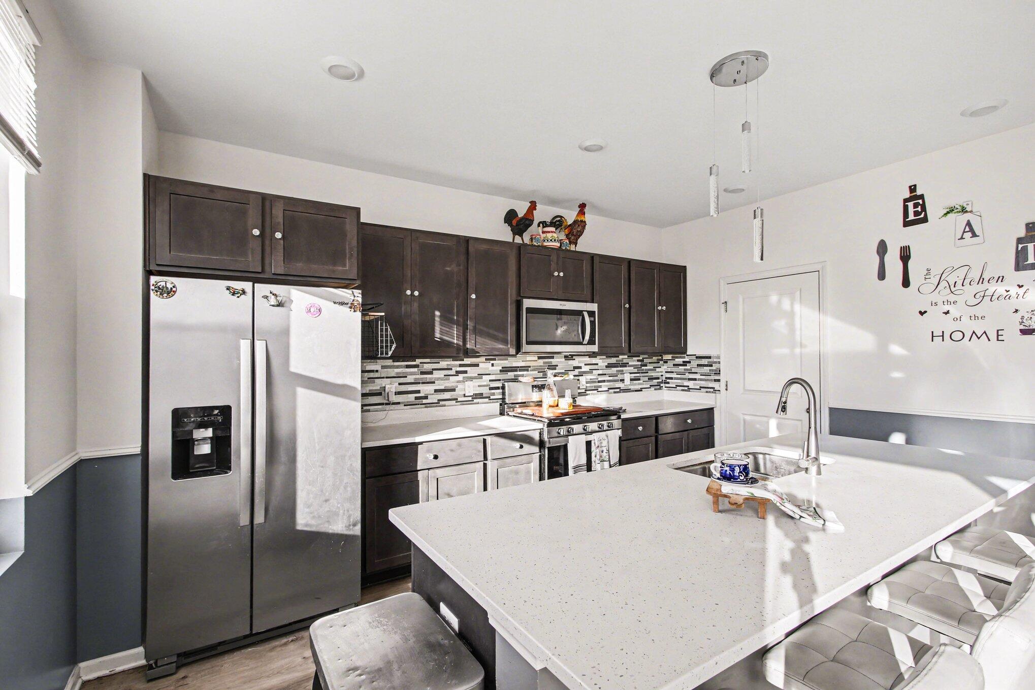 10560 Azalea Drive Crown Point, IN 46307 - Photo 8 of 26 a kitchen with stainless steel appliances a refrigerator and a stove