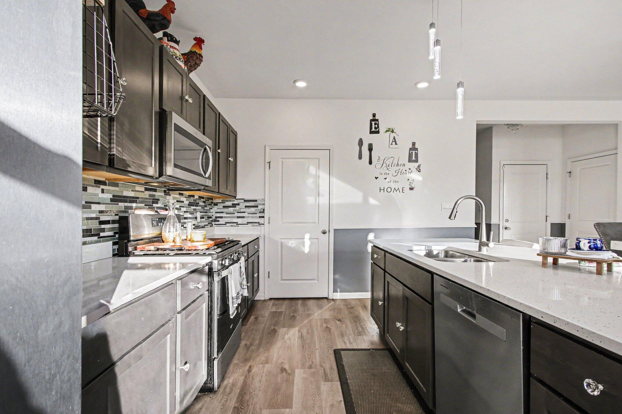 10560 Azalea Drive Crown Point, IN 46307 - Photo 9 of 26 a kitchen with a sink stove and cabinets