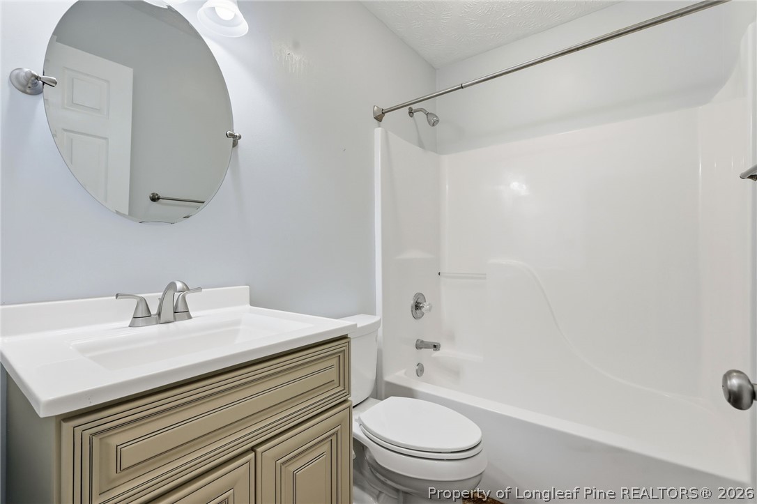 5113 Archer Road Hope Mills, NC 28348 - Photo 32 of 41 a bathroom with a sink toilet and shower