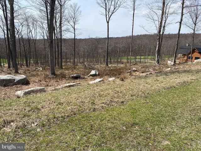 a backyard of a house with a table and chairs