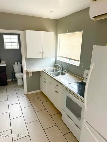 a kitchen with a stove a sink and a refrigerator