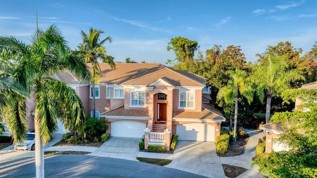 a front view of a house with a yard and a garage