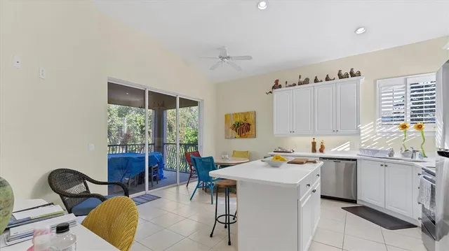 a kitchen with stainless steel appliances a sink a stove a microwave a sink a refrigerator and cabinets