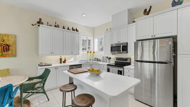 a living room with furniture a flat screen tv and kitchen view