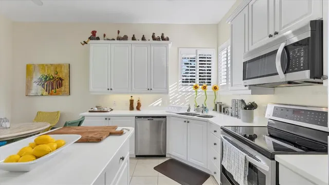 a view of a dining room with furniture wooden floor and chandelier
