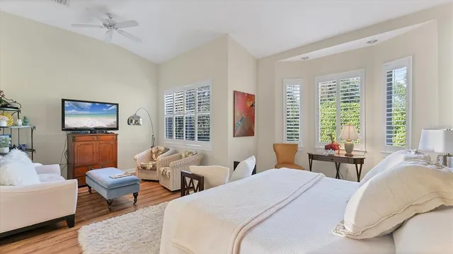a spacious bathroom with a double vanity sink a mirror a bathtub and next to a window