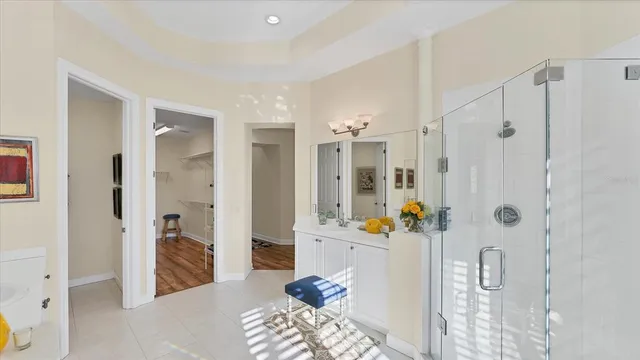 a bedroom with two beds and a chandelier