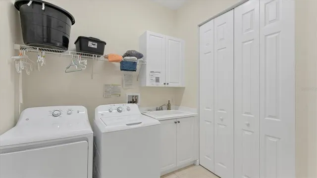 an aerial view of a city with lots of residential buildings ocean and mountain view in back