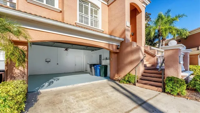 a sign board with a building and trees in the background