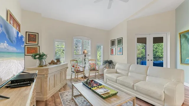 a living room with furniture a rug and a chandelier