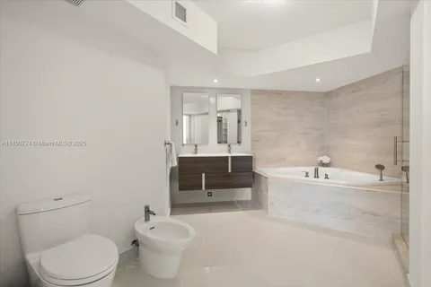 a bathroom with a toilet a sink and bathtub