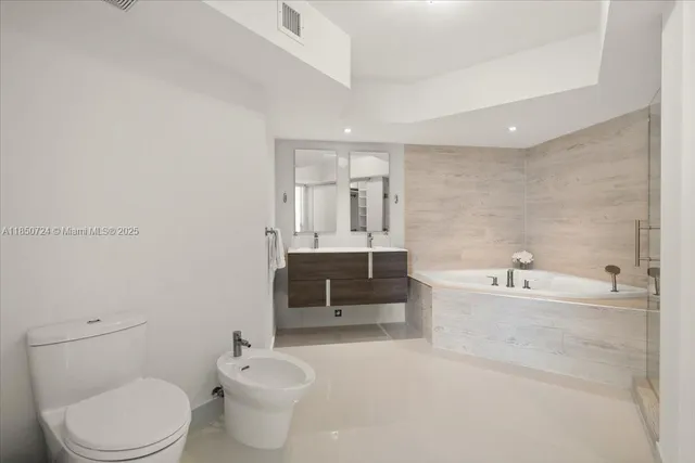 a bathroom with a toilet a sink and bathtub