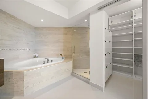 a spacious bathroom with a bathtub and a shower