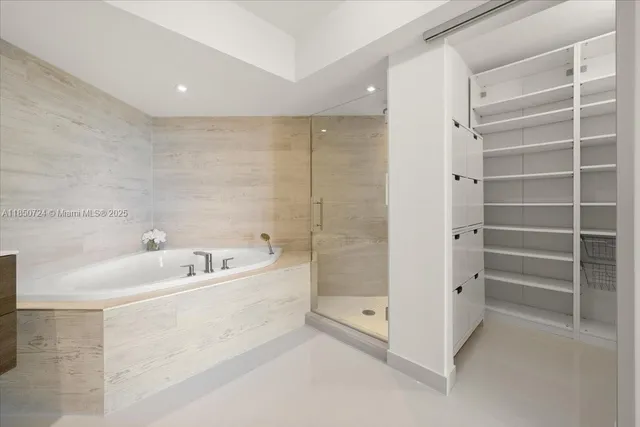 a spacious bathroom with a bathtub and a shower