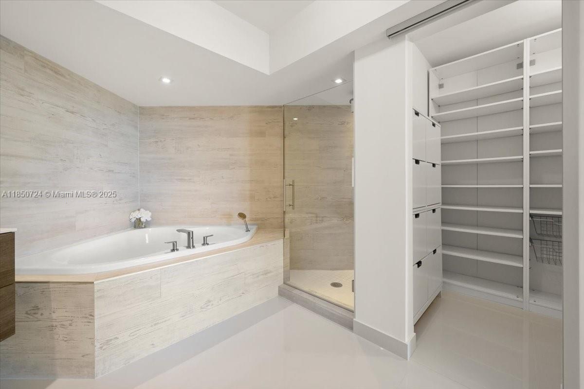 6301 Collins Avenue, Unit 2705 Miami Beach, FL 33141 - Photo 12 of 41 a spacious bathroom with a bathtub and a shower